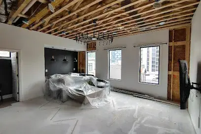 Ceiling opened to the joists with furniture covered in plastic