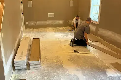 Technician working on an emptied floor with the flooring pulled up